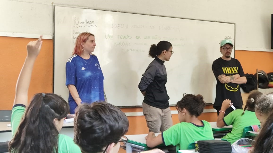 Voluntários em pé na sala.